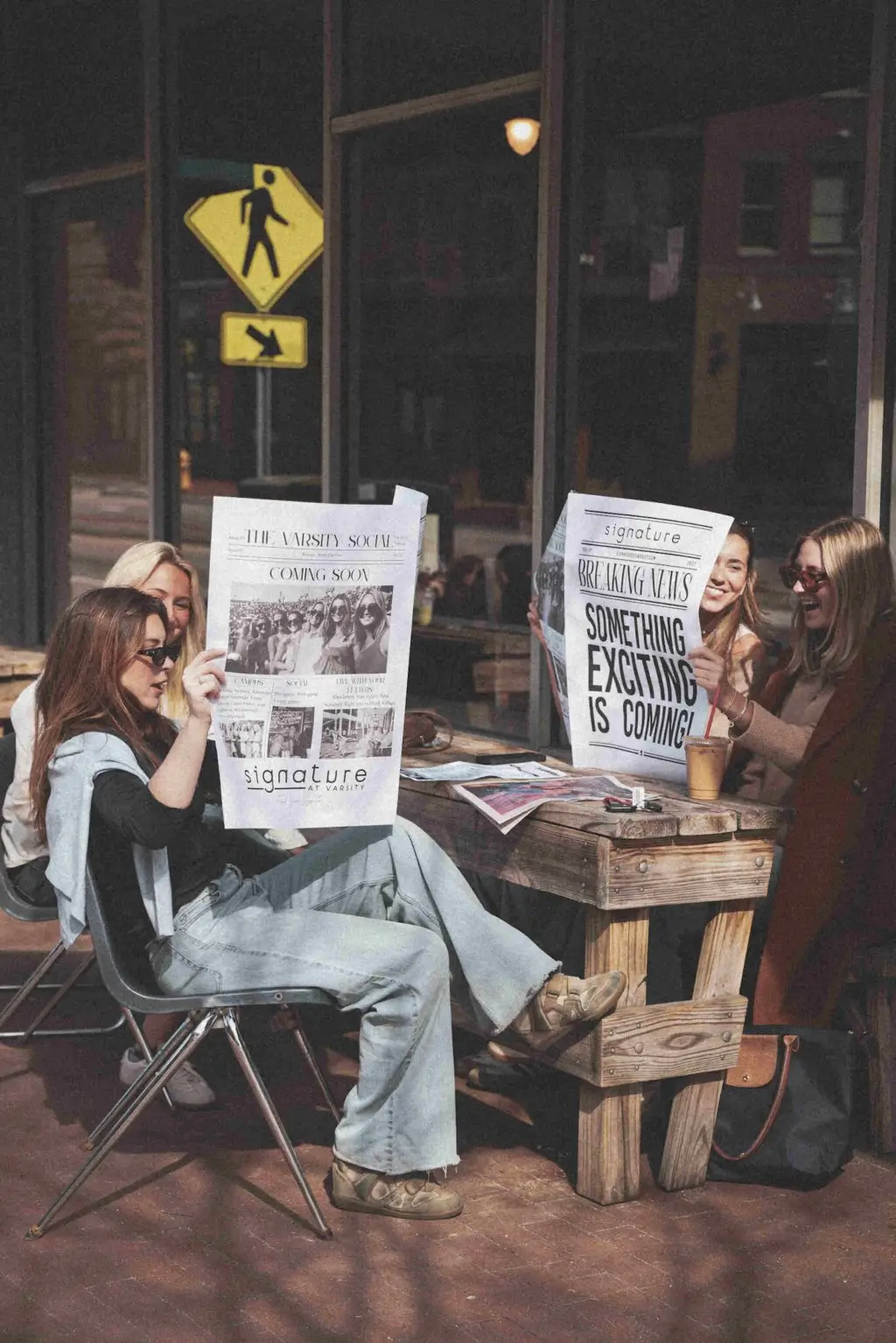 signature at varsity off campus apartments near nc state lifestyle shoot girls reading newspaper